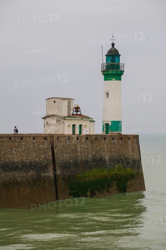 Top of the quay wall with lighthouse in the harbour of the coastal town of Le Treport at the mouth of the Bresle on the English Channel