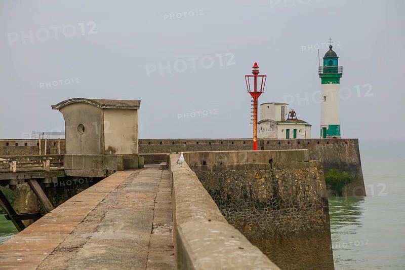 Top of the quay wall with lighthouse in the harbour of the coastal town of Le Treport at the mouth of the Bresle on the English Channel