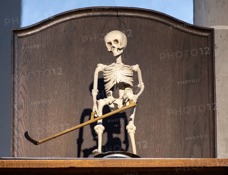 Rotating figure of the Death of Altoetting above a grandfather clock in the collegiate parish church of St. Philip and St. James
