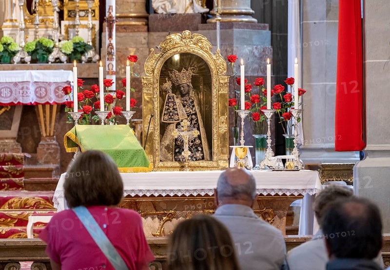 Worshippers sit in front of the Black Madonna in the collegiate parish church of St. Philip and St. James in the pilgrimage town of Altoetting. The image of grace is normally in the Holy Chapel