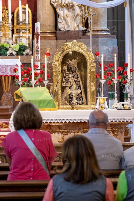 Worshippers sit in front of the Black Madonna in the collegiate parish church of St. Philip and St. James in the pilgrimage town of Altoetting. The image of grace is normally in the Holy Chapel