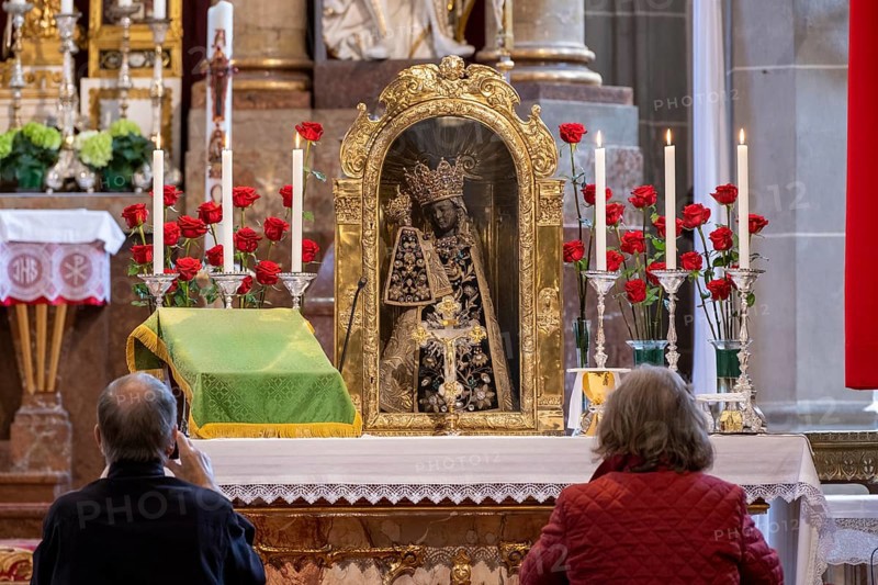 Worshippers sit in front of the Black Madonna in the collegiate parish church of St. Philip and St. James in the pilgrimage town of Altoetting. The image of grace is normally in the Holy Chapel