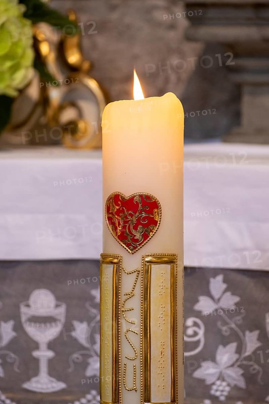 Candle with red heart and inscription Jesus in the collegiate parish church of St. Philip and St. James
