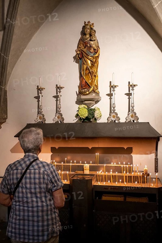 Image of the Virgin Mary over candles in the collegiate parish church of St. Philip and St. James