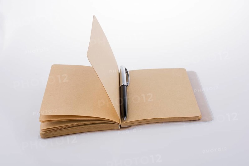 Pen on a notebook on a white background