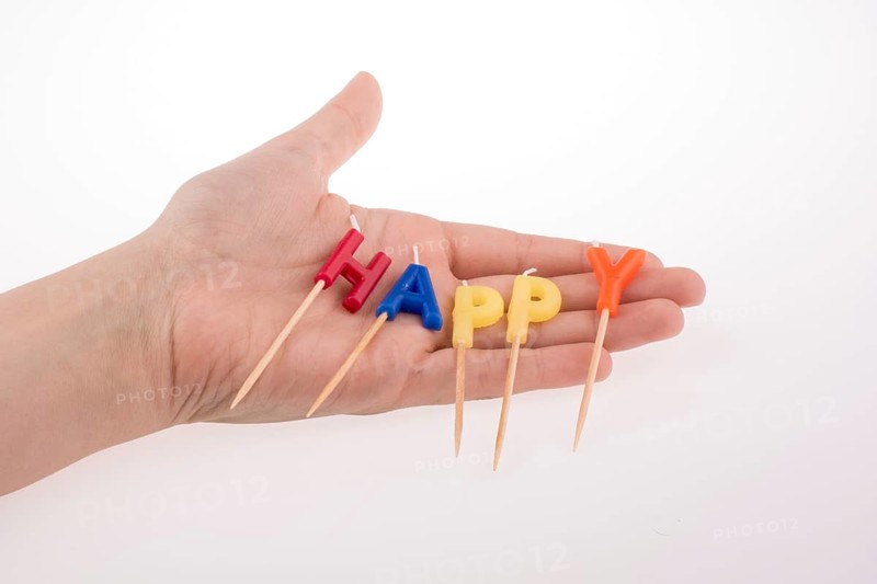 Color candles on sticks write the word happy