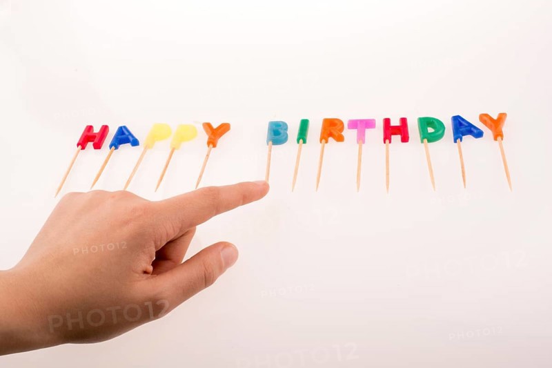 Hand and color candles on sticks write the words happy birthday