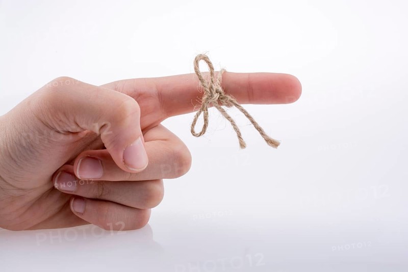 Hand tied with a thread like a ribbon on a white background