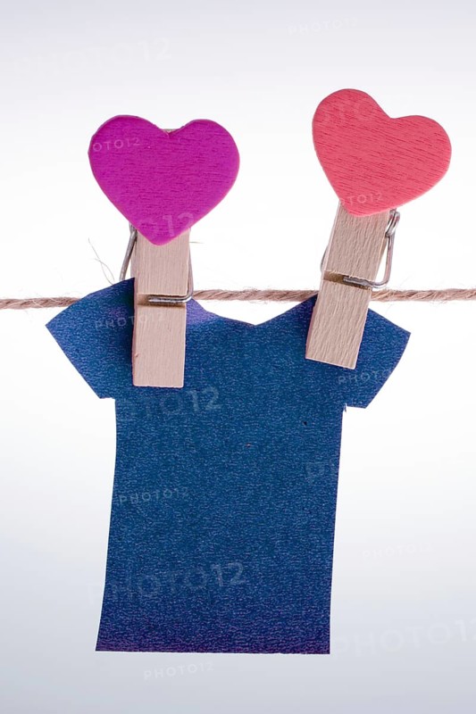 Paper clothes hang on a rope with the help of clothespins