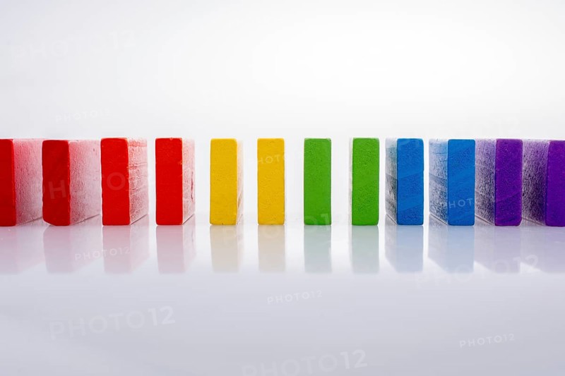 Colorful Domino Blocks in a line on a white background