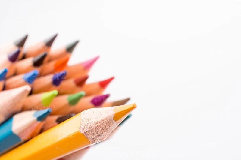 Color pencils of various colors on a white background