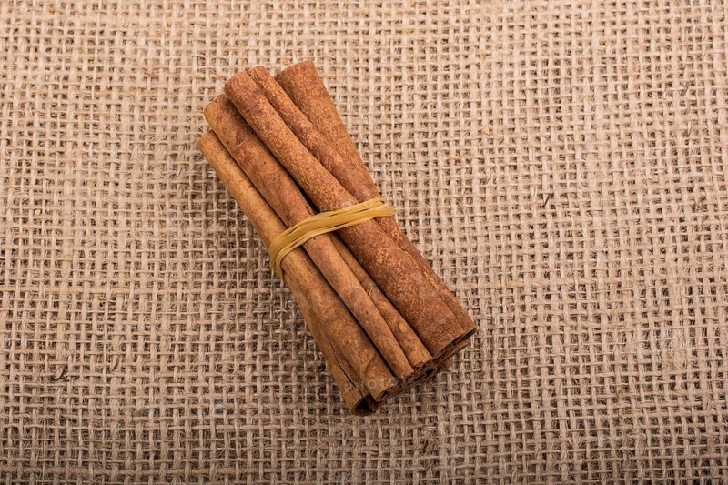 Bundle of cinnamon sticks on a linen canvas background