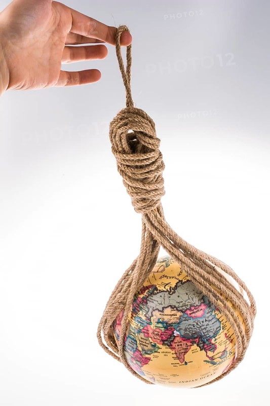 Globe hanging in rope on white background
