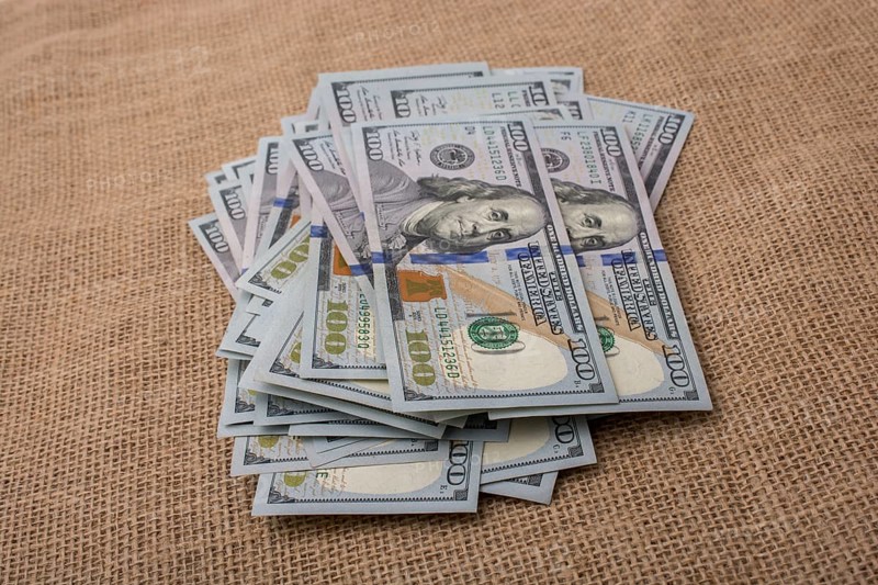 Banknote bundle of US dollar placed on a linen canvas