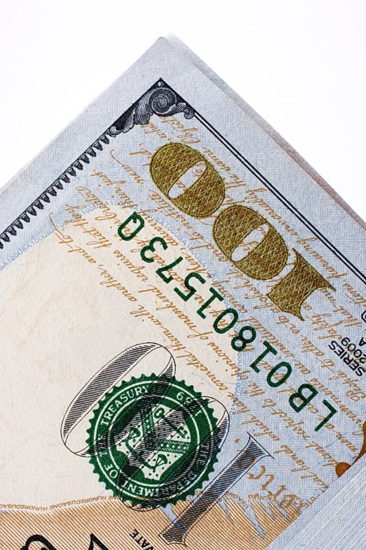American 100 dollar banknotes made of paper placed on white background