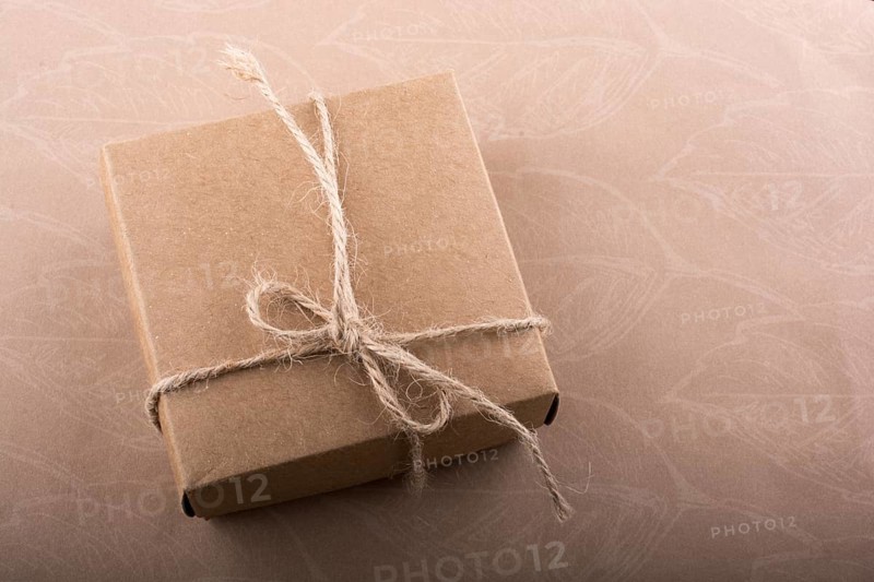 Gift box of a brown color and pine cone