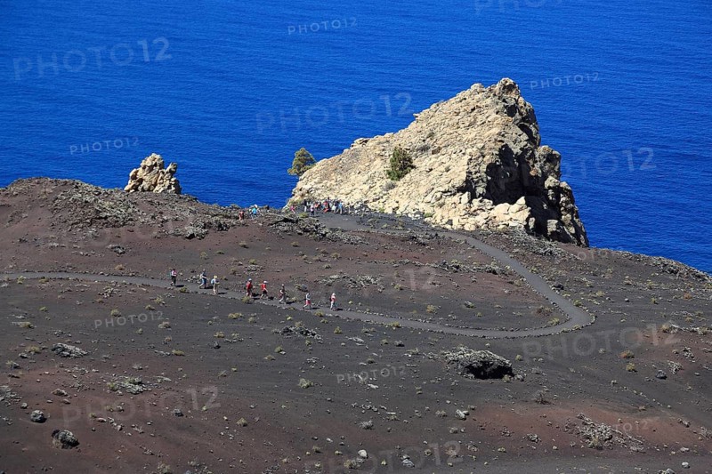 Hikers on the way from the volcano San Antonio to the volcano Teneguia at Cap Fuencaliente