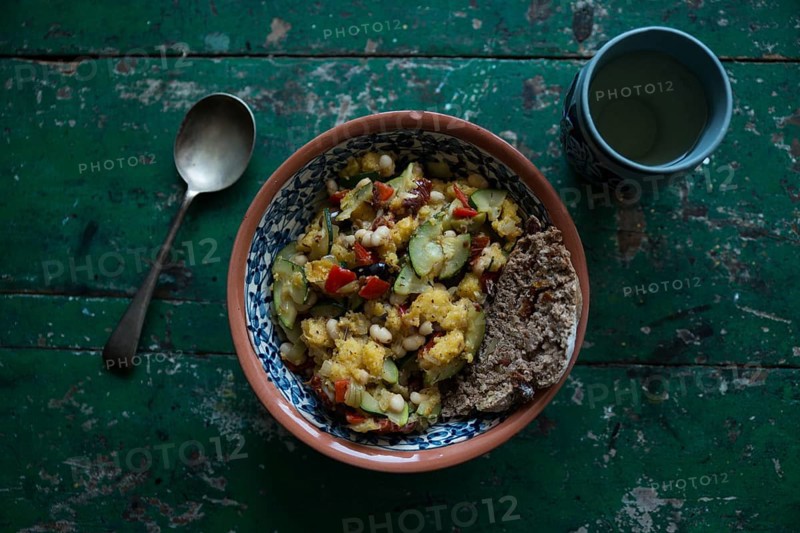Vegan dish with a cup of wine on a rustic wooden table