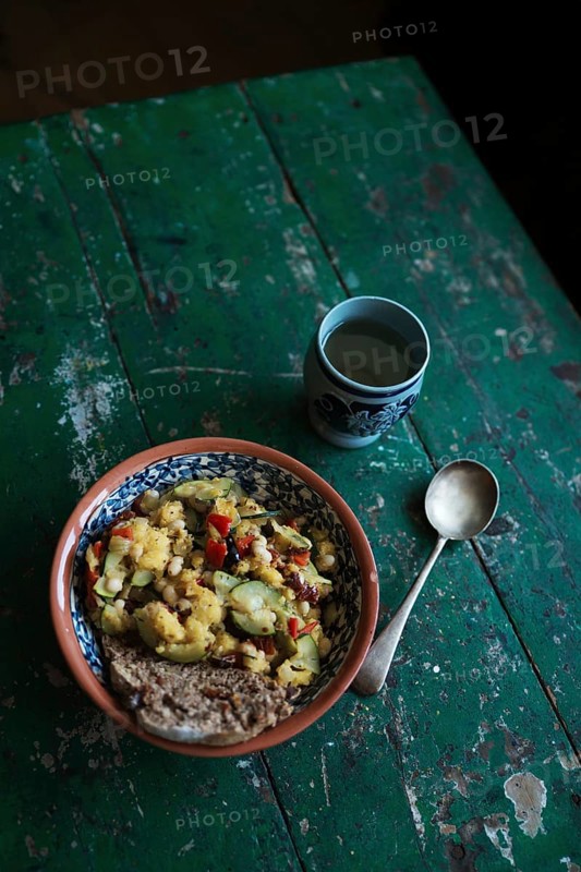 Vegan dish with a cup of wine on a rustic wooden table