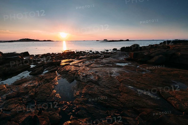 Rocks on the beach of Port Blanc in the evening light