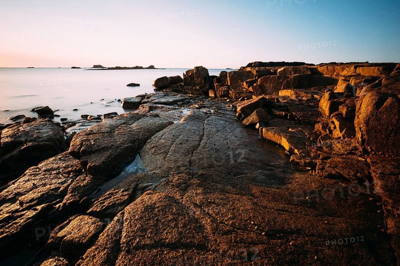 Rocks on the beach of Port Blanc in the morning light