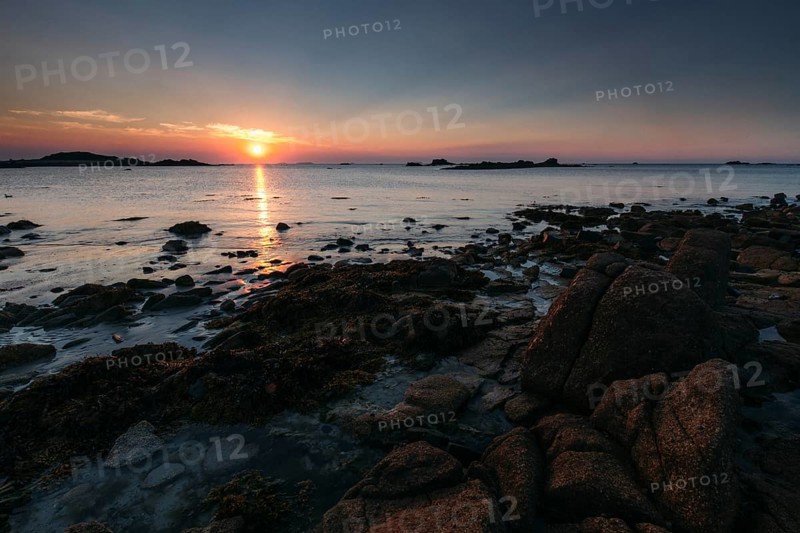 Rocks on the beach of Port Blanc in the evening light