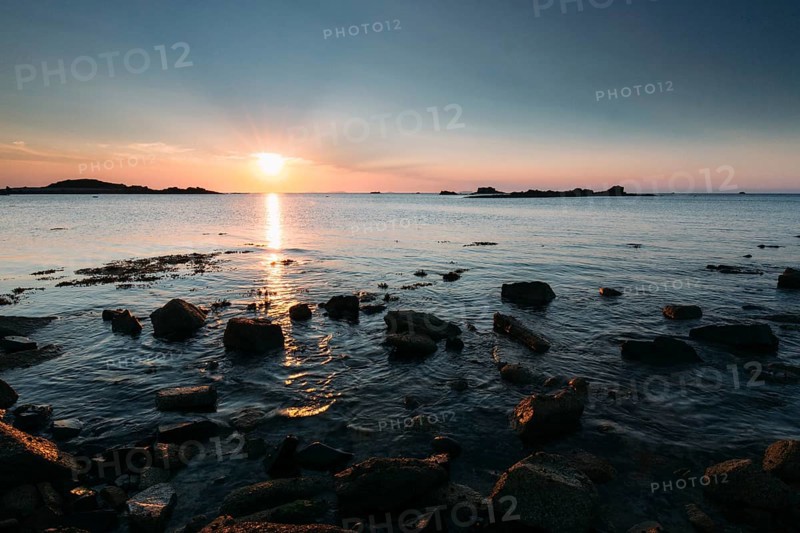 Rocks on the beach of Port Blanc in the evening light