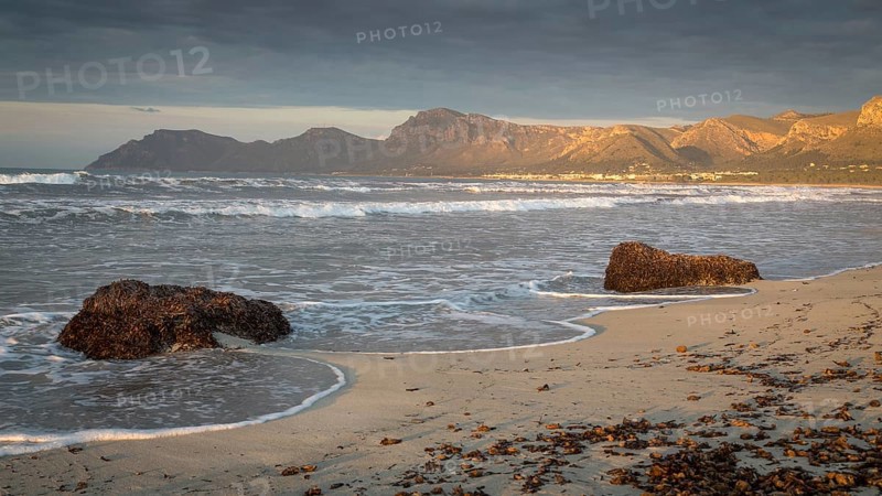 Evening atmosphere at the sandy beach Playa Sa Canova in Son Serra de Marina, in the back mountains Serres de Llevant