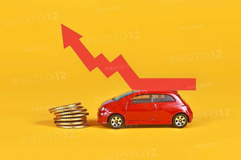 Small car with rising arrow and money coins on yellow background,
