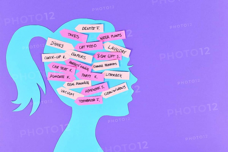Concept for mental load with woman's head silhouette with multiple tasks on notes,