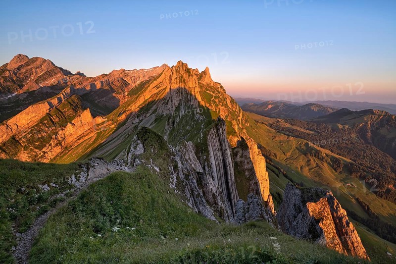 View of the Alpstein mountains in Appenzell, cloudless sky in the morning light