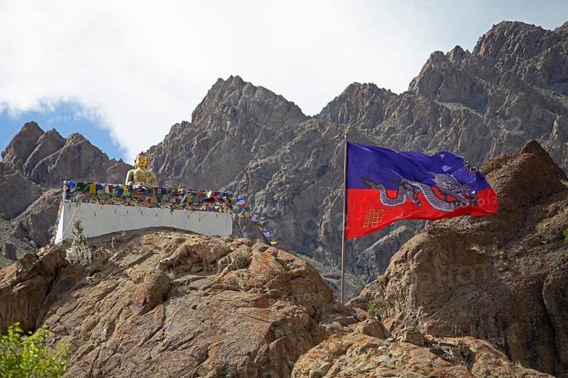 Maitreya Buddha and traditional Tibetan dragon flag, Hemis Gompa