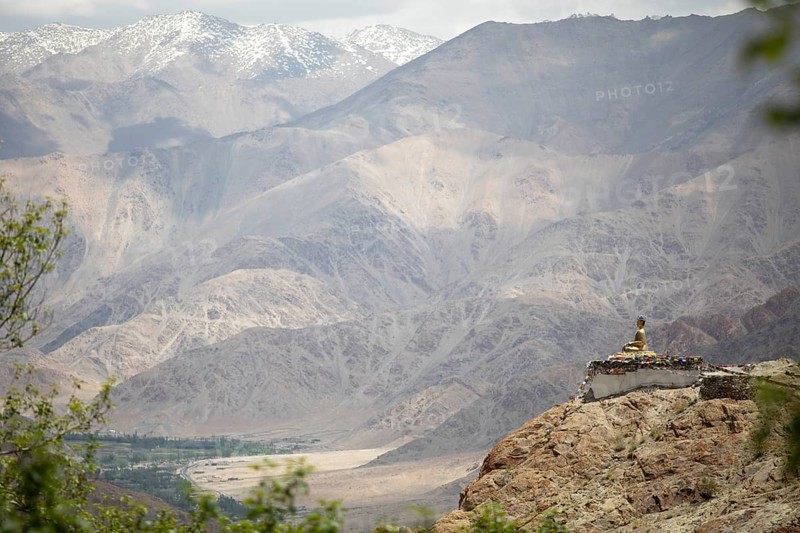 Maitreya Buddha at Hemis Gompa, Shang mountain range in the background