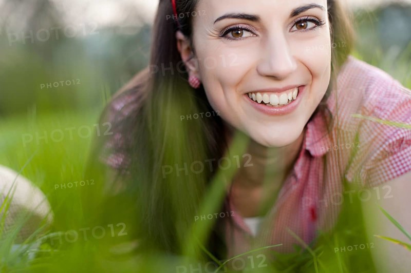 Young woman lying in meadow,
