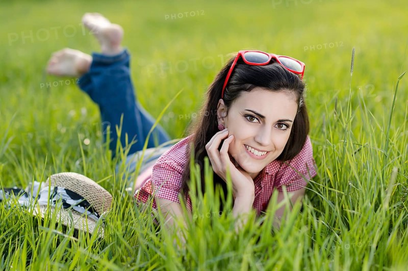 Young woman lying in meadow,