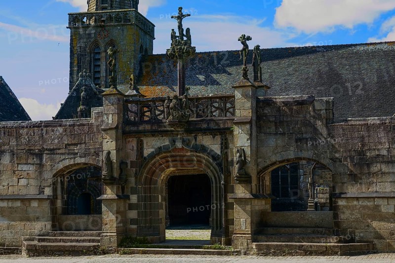 Enclosed parish Enclos paroissial Eglise Saint-Salomon de La Martyre with Gothic Flamboyant-style triumphal arch, Finistere department