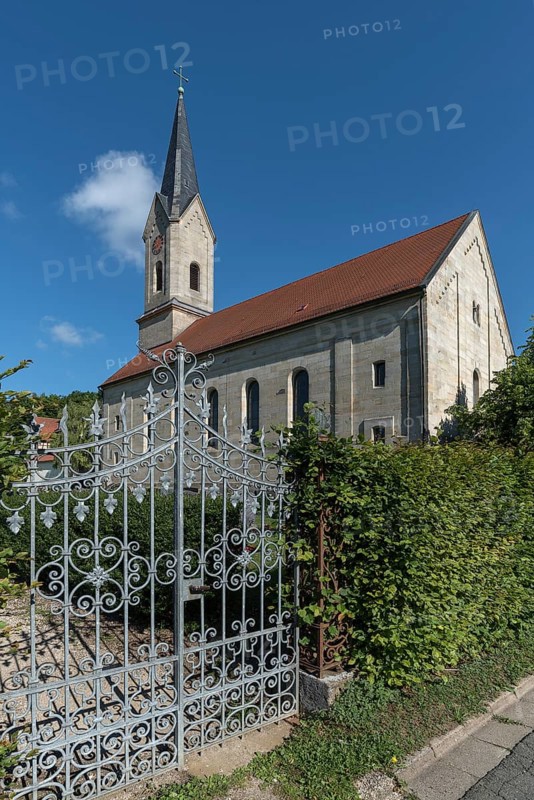 Wrought-iron gate of the cemetery, in the back the neo-Gothic St. Catherine's Church