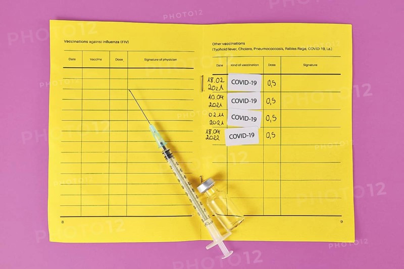 Concept for Corona virus booster vaccination showing vaccine passport with 4 entries,
