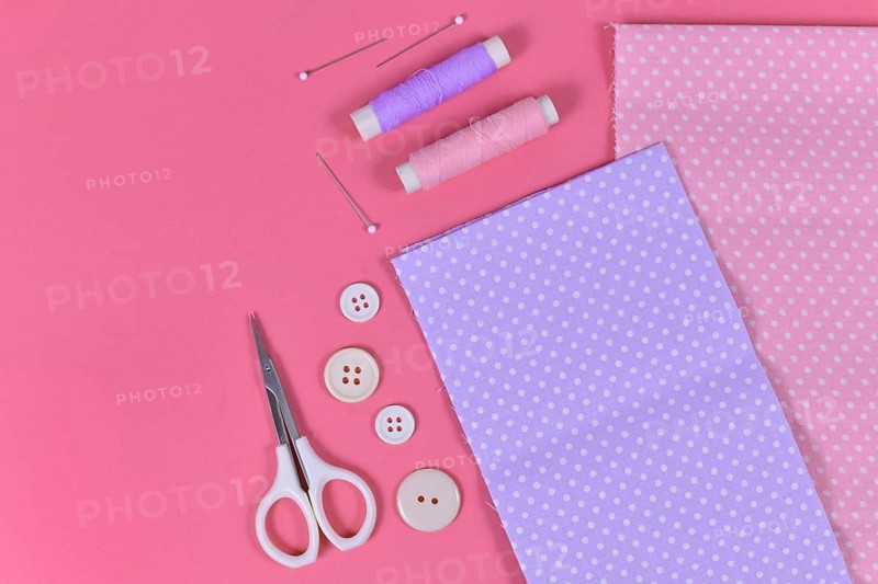 Flat lay with various sewing tools like fabric, scissors