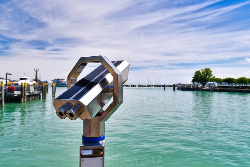 Telescope binoculars at Lake Constanze at Konstanz harbor, a popular travel destination for tourists in Europe