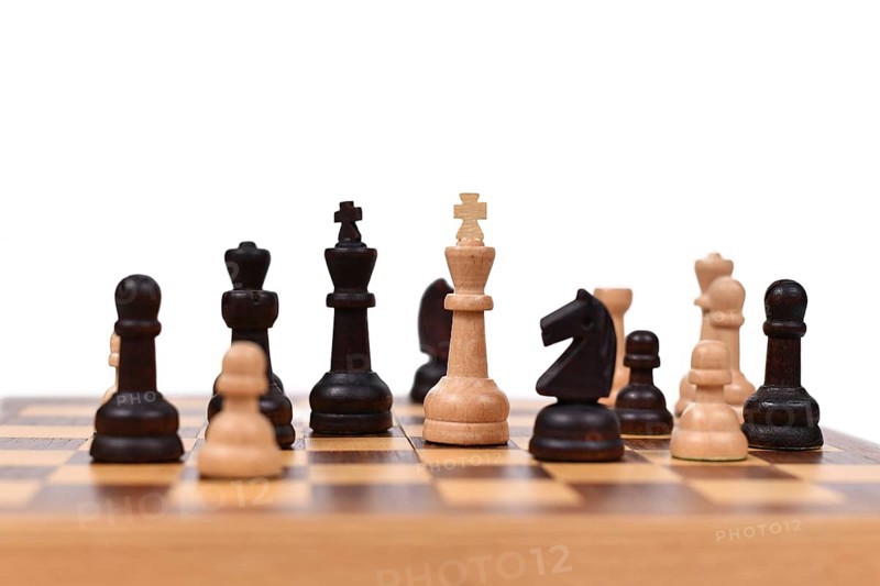 Chess board game with focus on white queen pieces on white background,