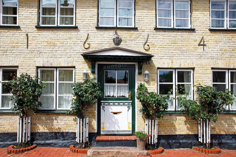 Old house from 1664 with decorative wooden door, Historic fishing settlement Holm