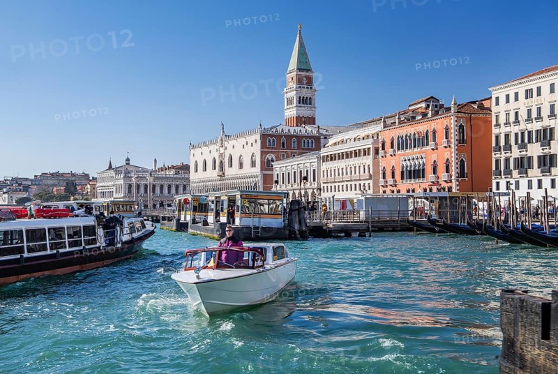 Water taxi in front of the waterfront with Doge's Palace, Campanile and Hotel Danieli