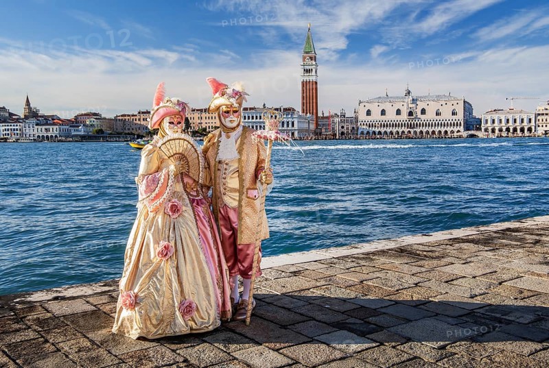 Carnival masks in front of the panorama of the city with Campanile and Doge's Palace, Venice