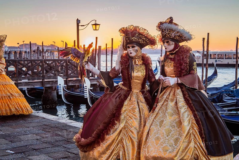 Carnival masks on the waterfront at sunrise, Venice