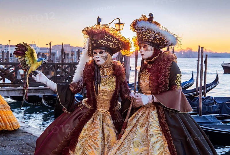 Carnival masks on the waterfront at sunrise, Venice