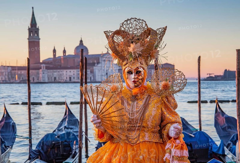 Carnival mask on the waterfront at sunrise, Venice