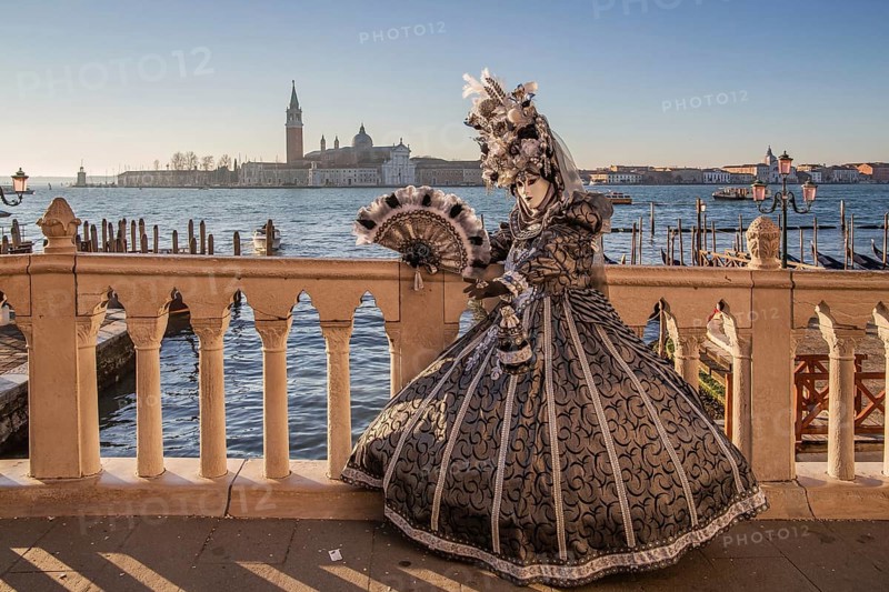 Carnival mask on the waterfront in front of San Giorgio Island, Venice
