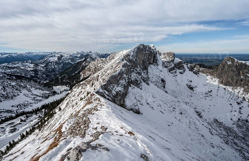 Snow-covered rocky mountain ridge, behind peak of Kraehe