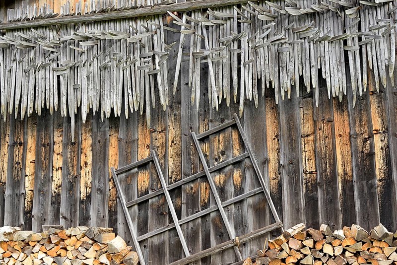 Shed wall with suspended hay riders,